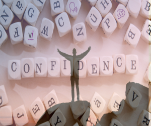 A figure in sihouette overlayed on a picture of cubes with letters spelling the word confidence.